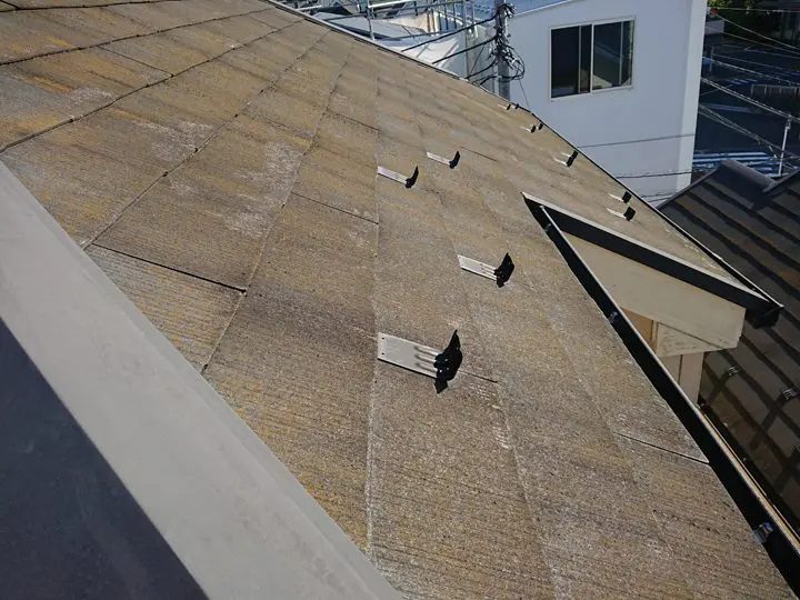 色あせて苔が生えているスレート屋根